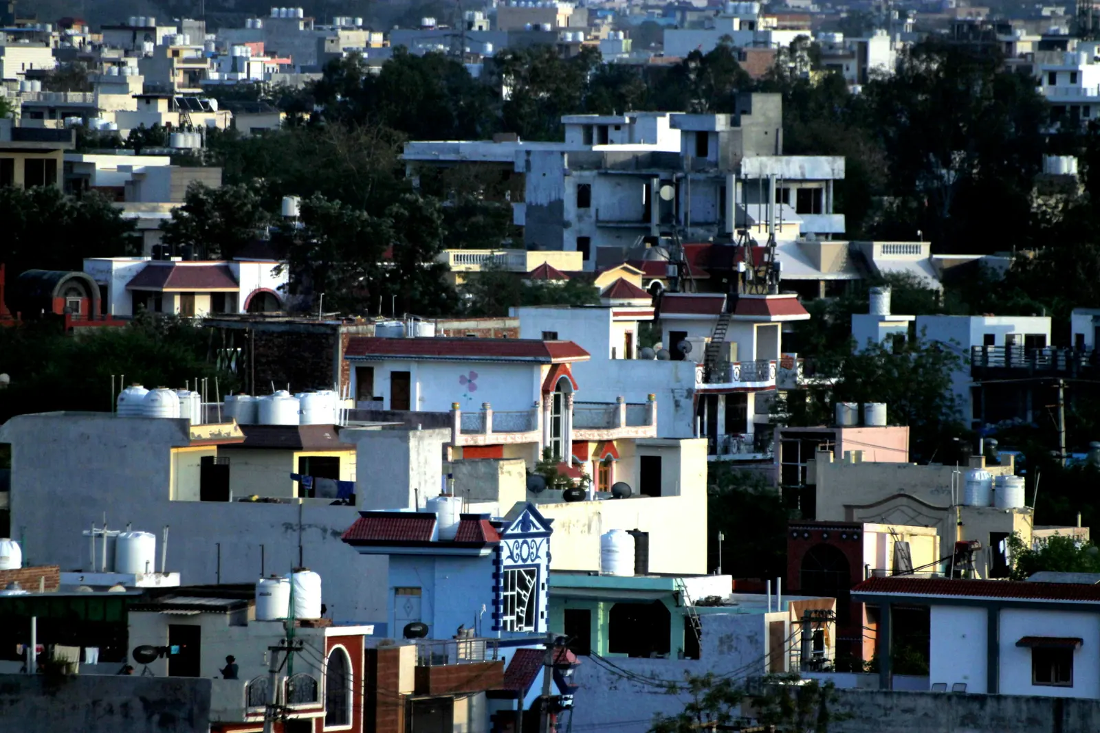 Hillside of houses and apartment blocks in an Indian city