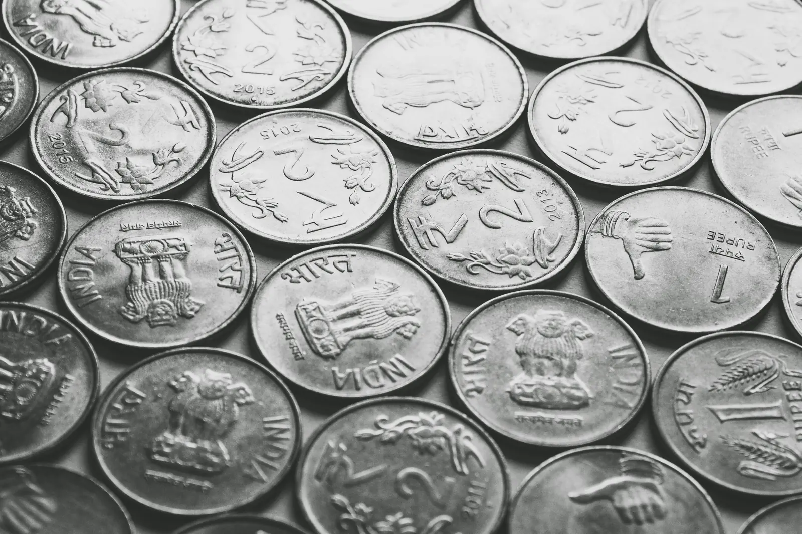 Black-and-white pattern of one and two rupee coins
